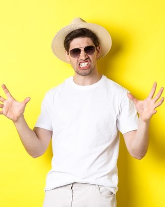 tourism-travelling-holidays-concept-sassy-young-man-vacation-showing-something-big-clenching-teeth-standing-sunglasses-summer-hat_1258-40964